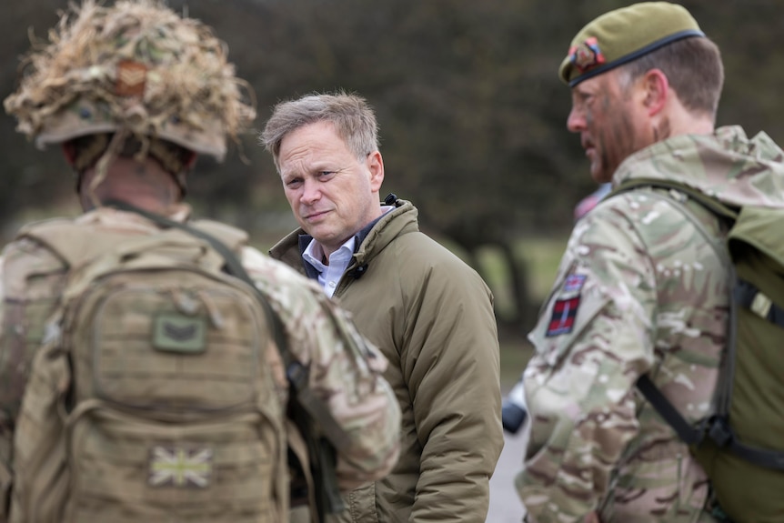 British Defence Secretary Grant Shapps meets with troops at a garrison.