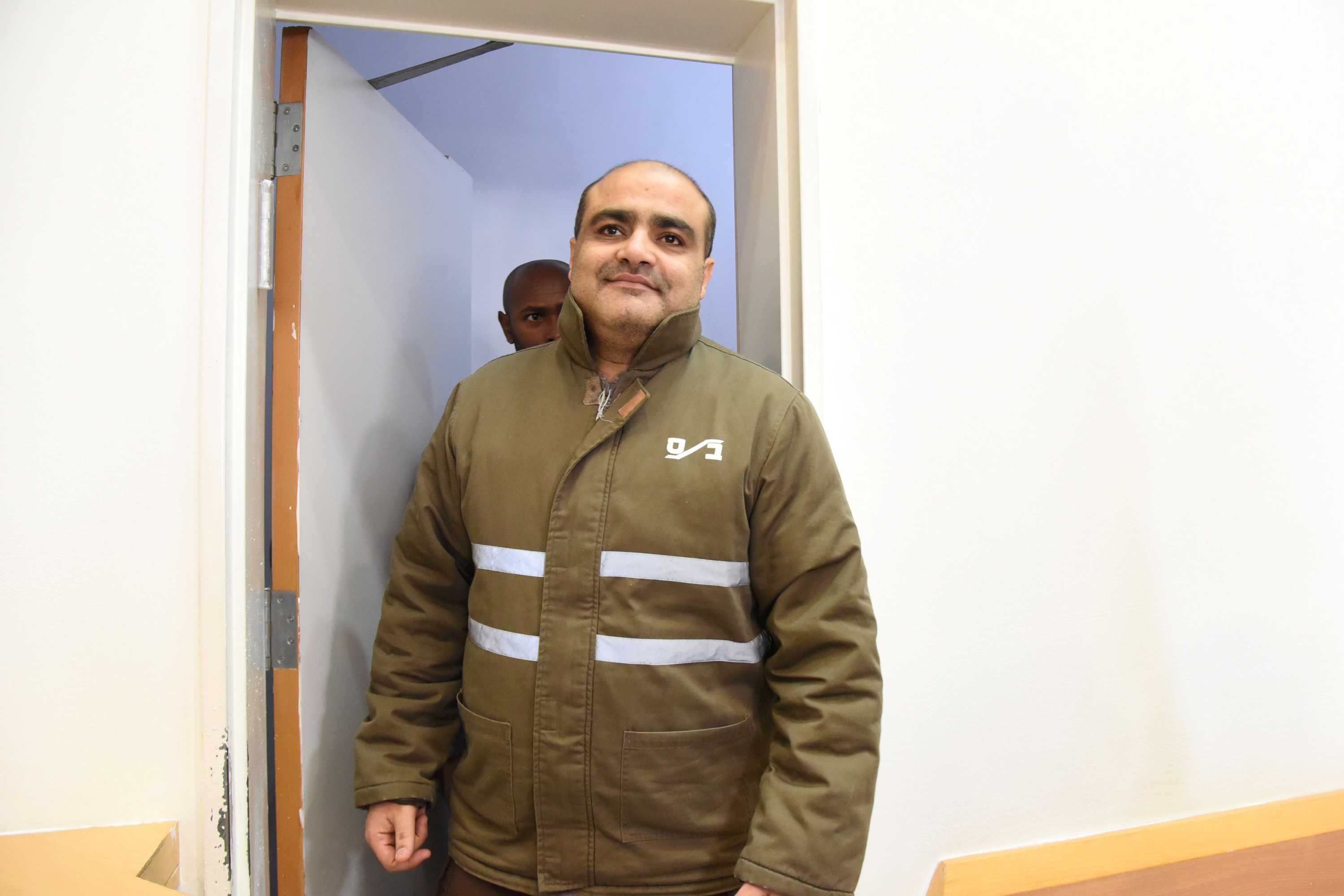Mohammed El Halabi, director of the Gaza branch of World Vision, wearing a green jacket in a court room.