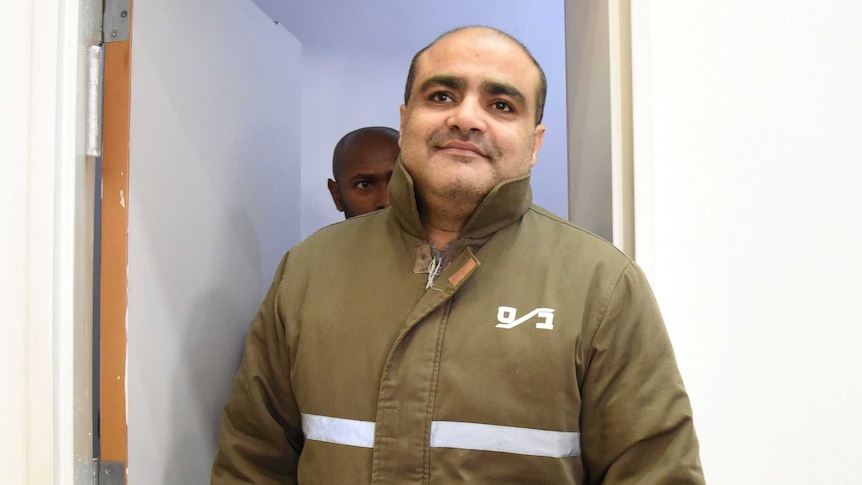 Mohammed Al Halabi, director of the Gaza branch of World Vision, wearing a green jacket in a court room.