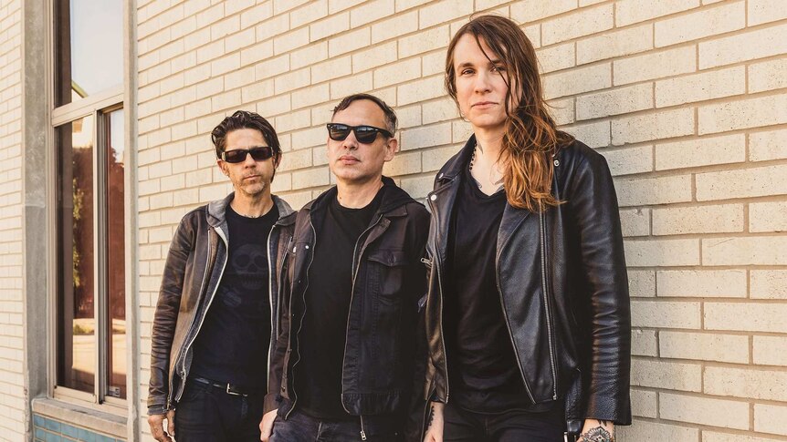 Laura Jane Grace with two  guys