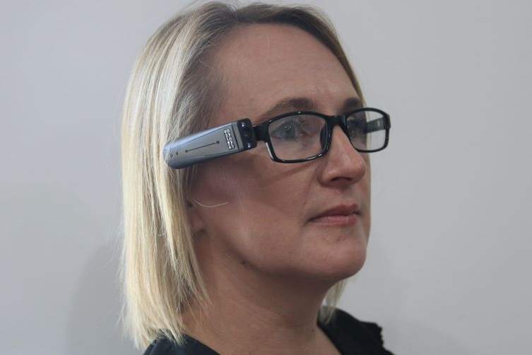 Woman with aphasia wearing a glass-mounted text-to-speech tool