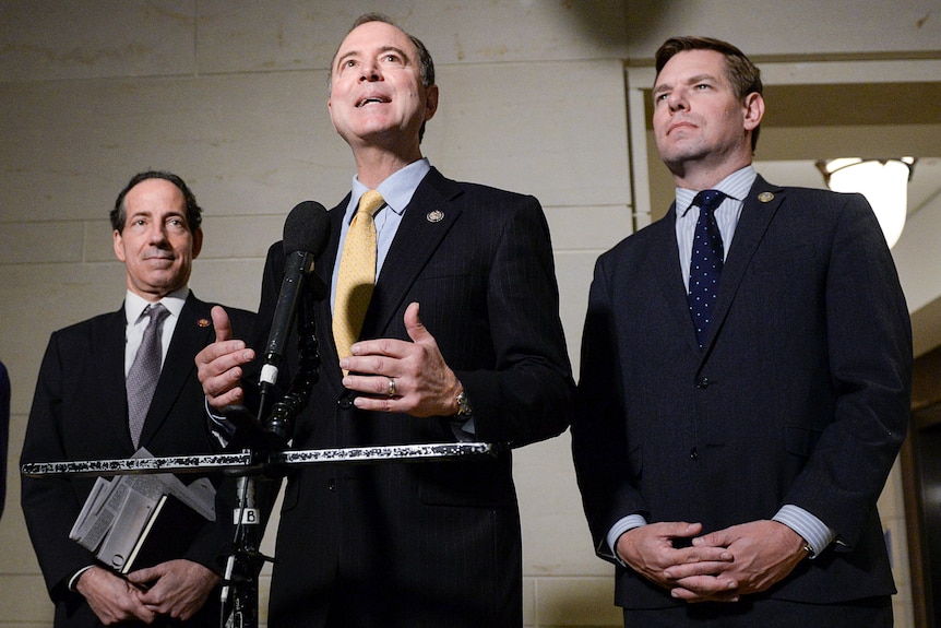 Democrats Eric Schiff and Eric Swalwell speak to reporters from a podium back in 2019.