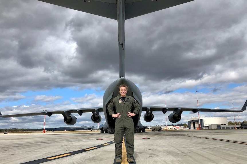 Brisbane Lions player Maria Maloney poses with a C-17 Globemaster in army gear.