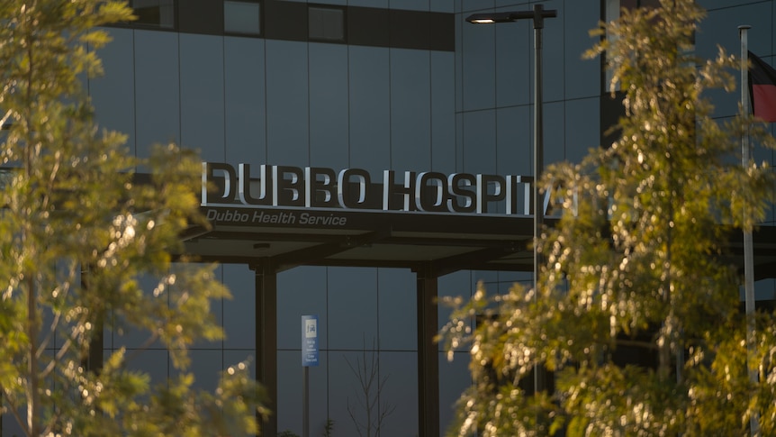 A sign reading 'Dubbo Hospital' in between two trees