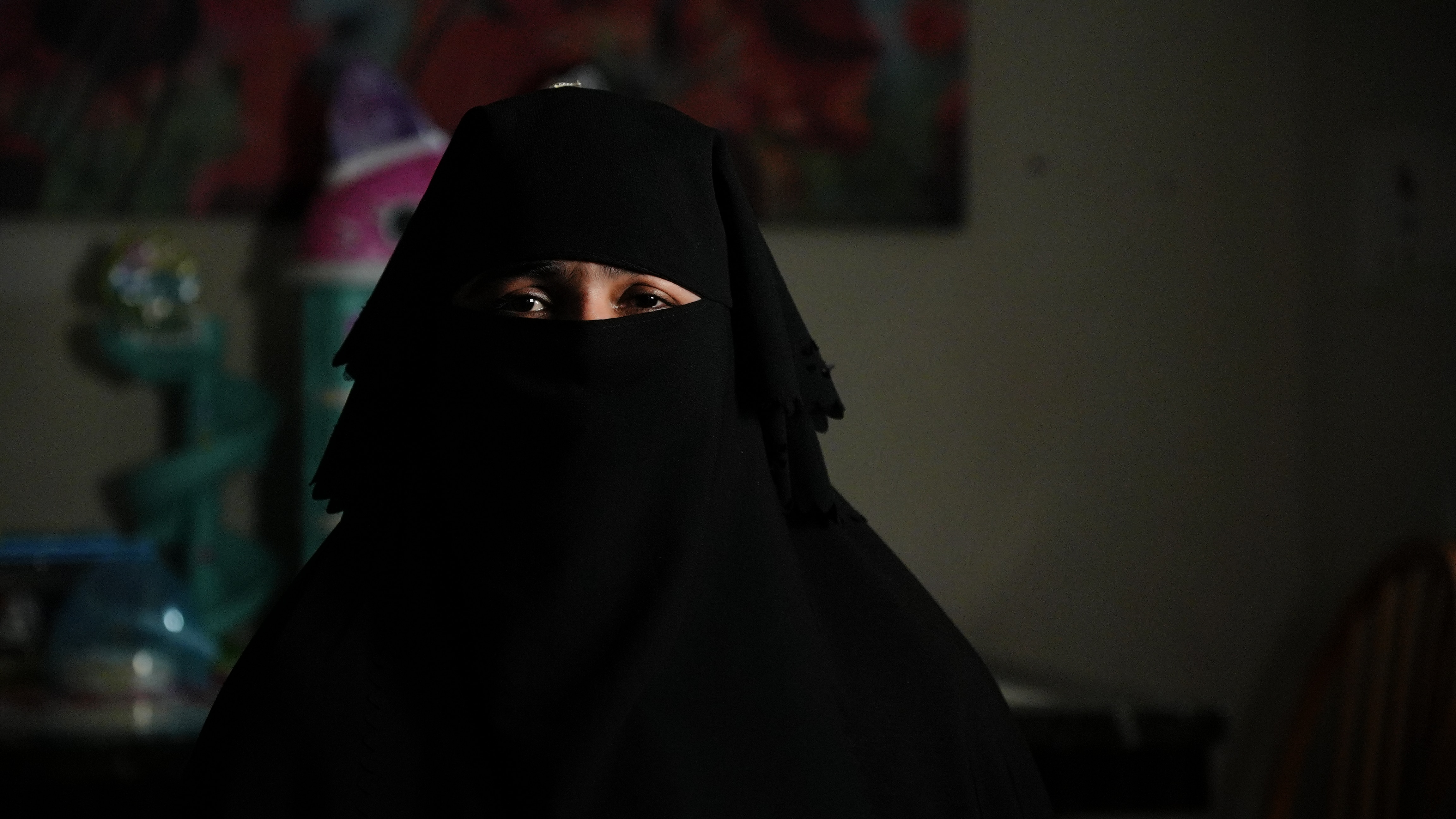 A woman in traditional Muslim burka looking into the camera.