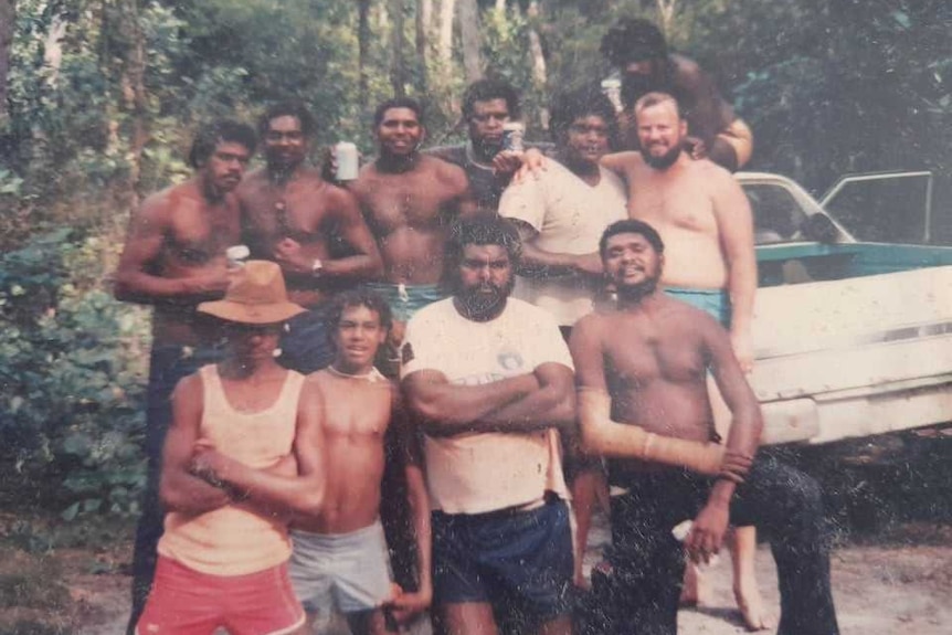 Group of Indigenous men with white man