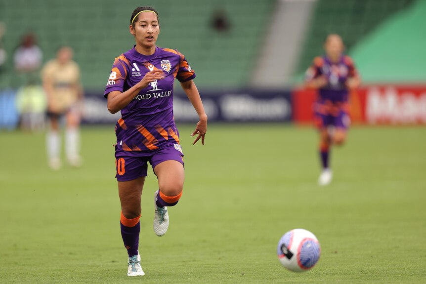 Perth Glory player Quinley Quezada chases the ball during a game.