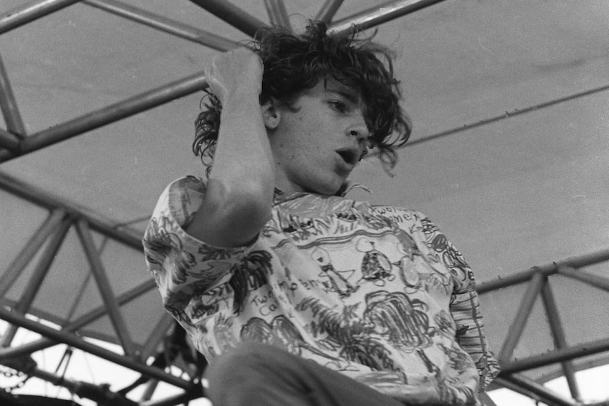 Black and white image of a man in mid dance onstage