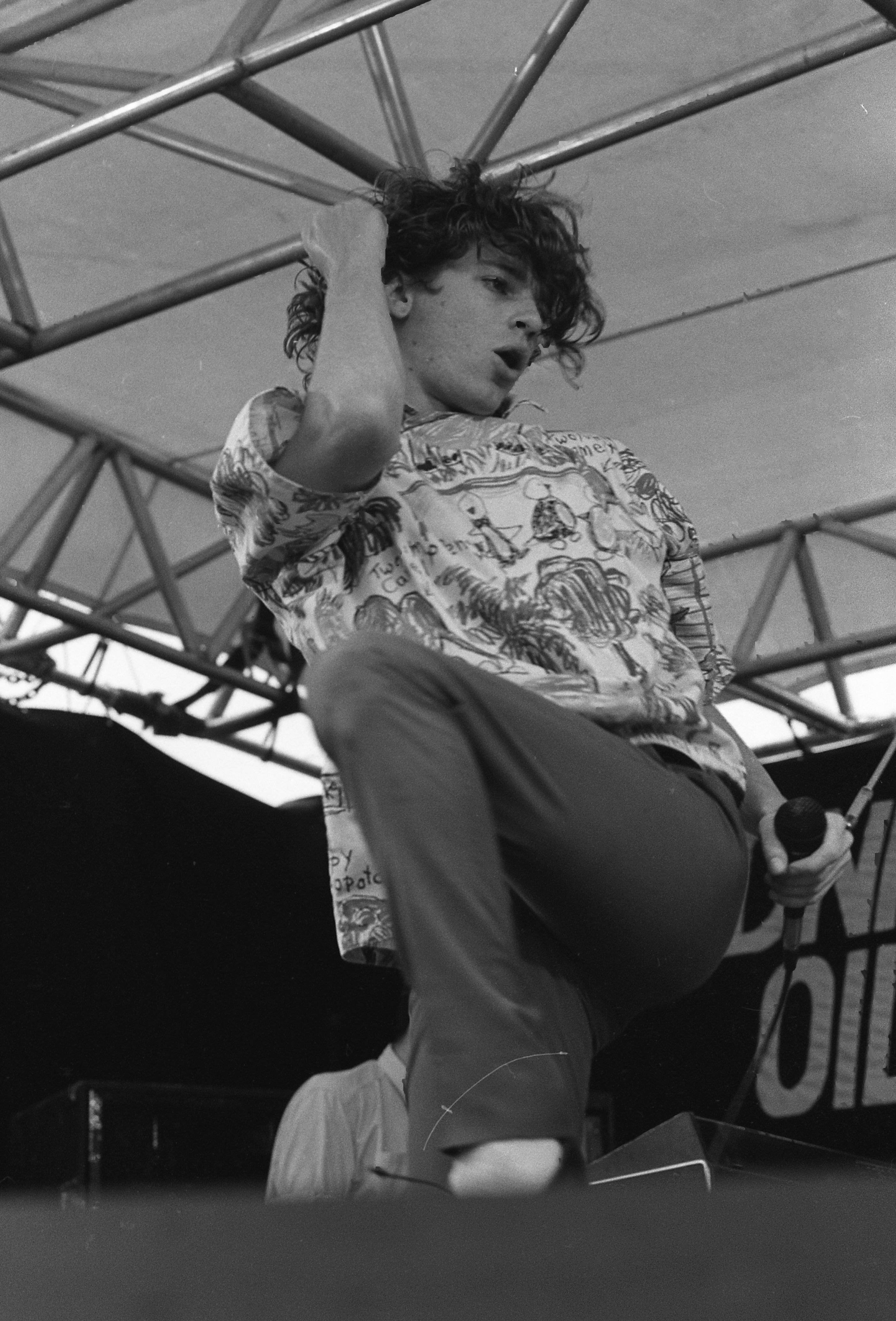 Black and white image of a man in mid dance onstage