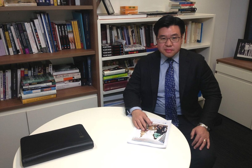 Race Discrimination Commissioner Tim Soutphommassane sitting in an office.