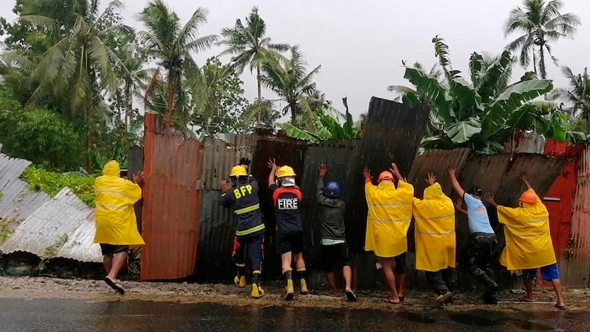 Crews lifting a fence