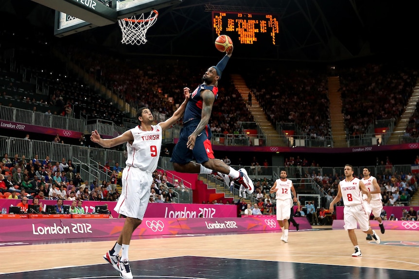 Cop that... LeBron James dunks over Mohamed Hadidane at the London Olympics.