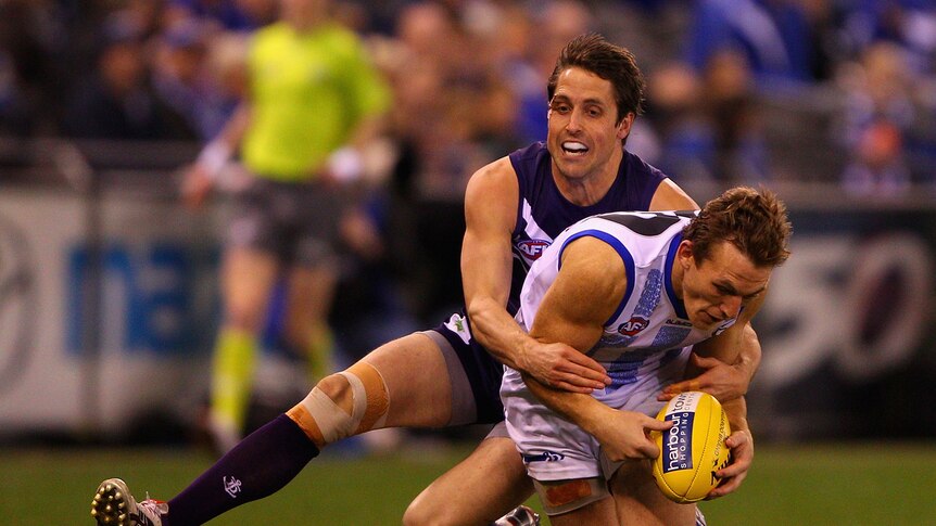 Fremantle's Luke McPharlin (L) is expected to miss two to three weeks with a hamstring injury.