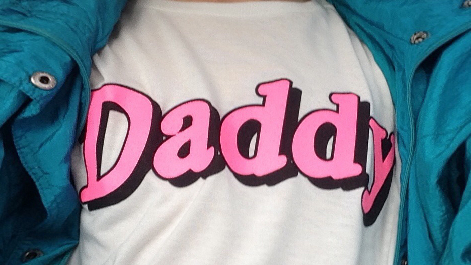 A person wearing a 'Daddy' t-shirt.