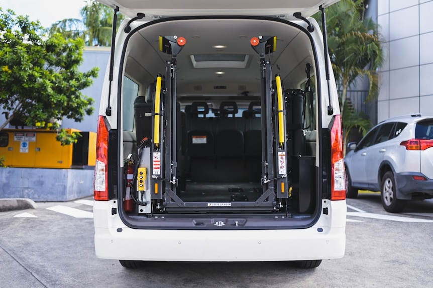 The rear door is opened on a wheelchair accessible taxi.