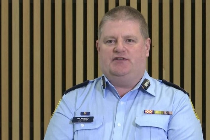 A man in a blue SES uniform speaks