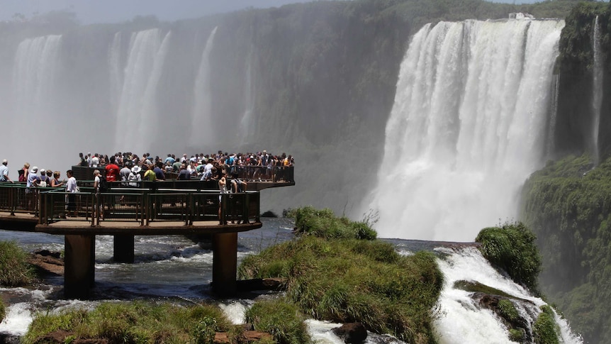 Tourists look at Iguazu Falls from an observation platform at the Iguazu National Park