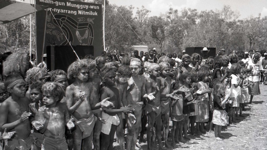 A black and white photo of Aboriginal children in traditional dress.