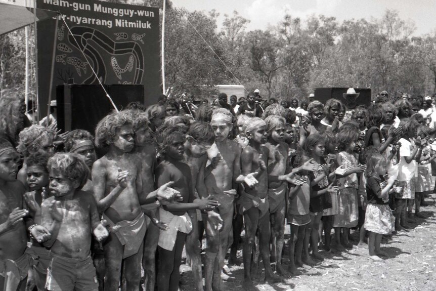 A black and white photo of Aboriginal children in traditional dress.