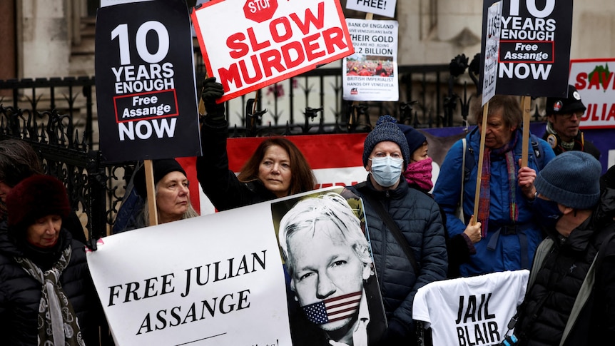 Supporters of WikiLeaks founder Julian Assange protest outside the Royal Courts.