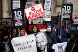 Supporters of WikiLeaks founder Julian Assange protest outside the Royal Courts.