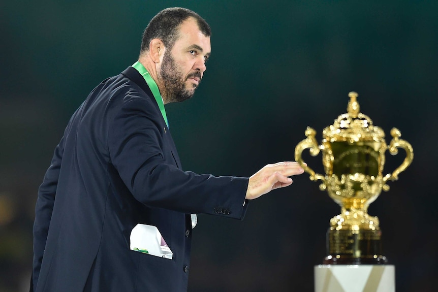 Wallabies coach Michael Cheika walks past the Webb Ellis Trophy after the 2015 Rugby World Cup final.