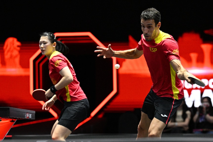 Mixed table tennis players hitting a ping pong ball during a match.