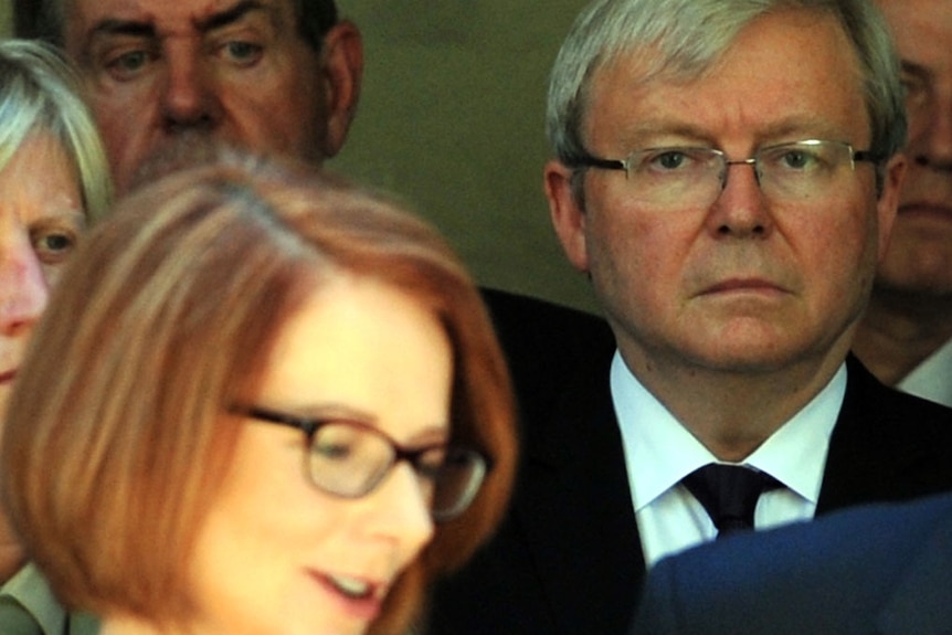 Julia Gillard with Kevin Rudd glaring behind, March 5 2013