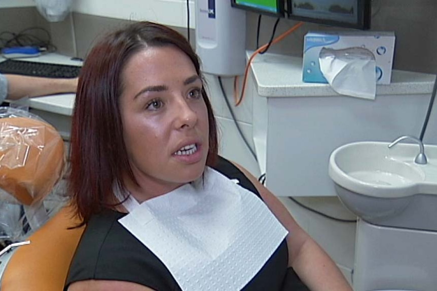 Darwin dental patient Sarah Healy sits in dentist chair.