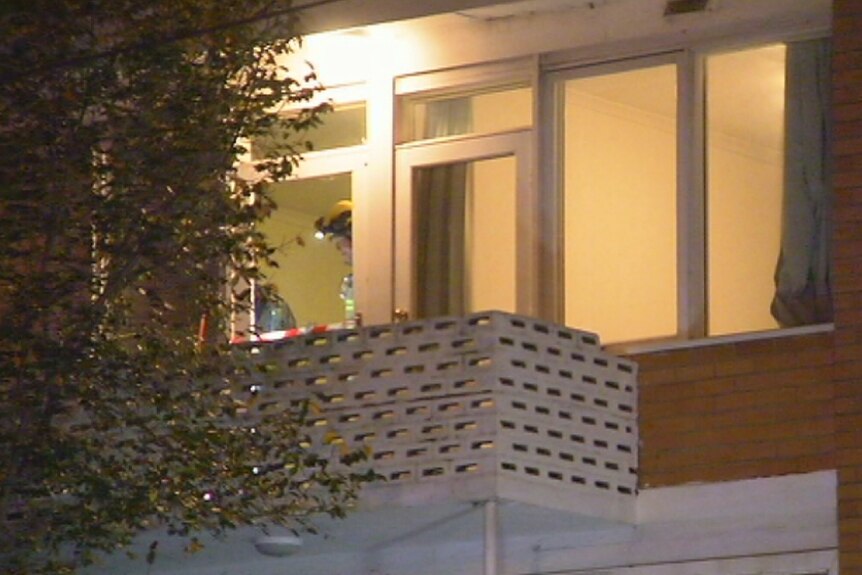 Investigators examine a South Yarra balcony where a woman fell.
