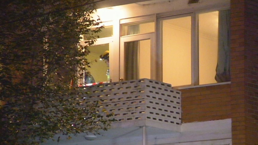 Investigators examine a South Yarra balcony where a woman fell.