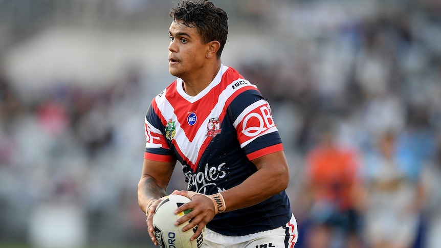 Latrell Mitchell of the Roosters runs the ball during a match between the Sydney Roosters and the Gold Coast Titans