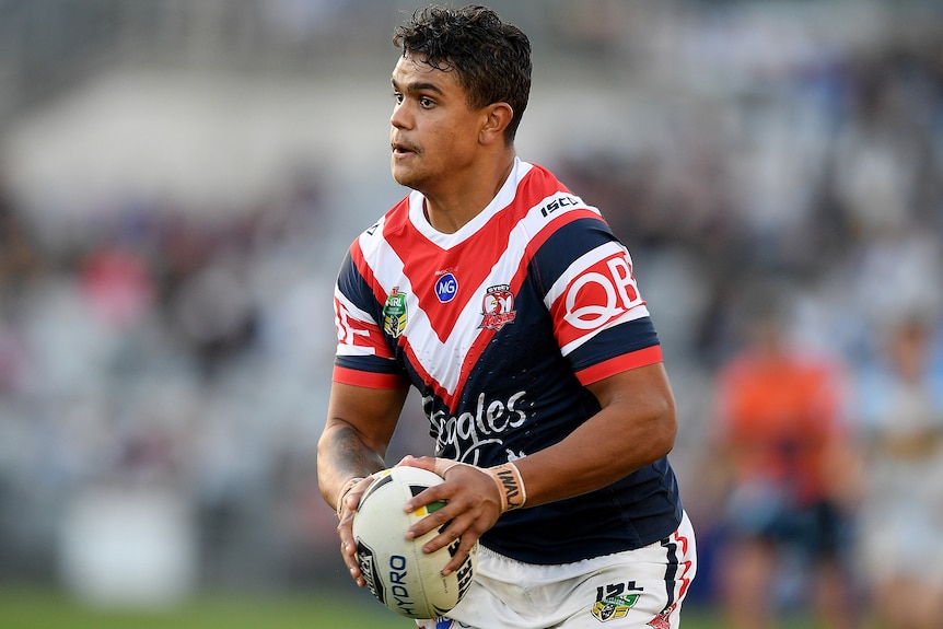 Latrell Mitchell of the Roosters runs the ball during a match between the Sydney Roosters and the Gold Coast Titans