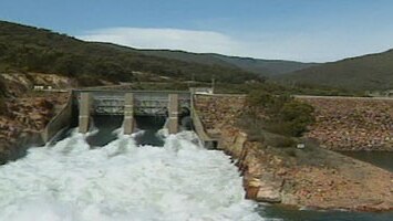 Whitewater flowing under a dam wall in the Snowy Mountains.