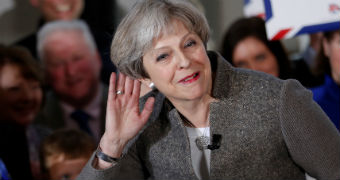 UK Prime Minister Theresa May gestures to a crowd during a rally