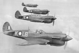 Four kittyhawk fighter planes patrol the skies over Horn Island in the Torres Strait during World War II.