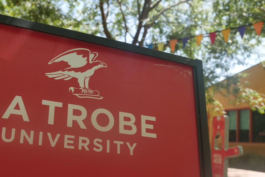 A university sign with bunting in thebackground