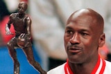 Michael Jordan, wearing his Chicago Bulls warm-up tracksuit, holds up the trophy as the NBA MVP in 1998.