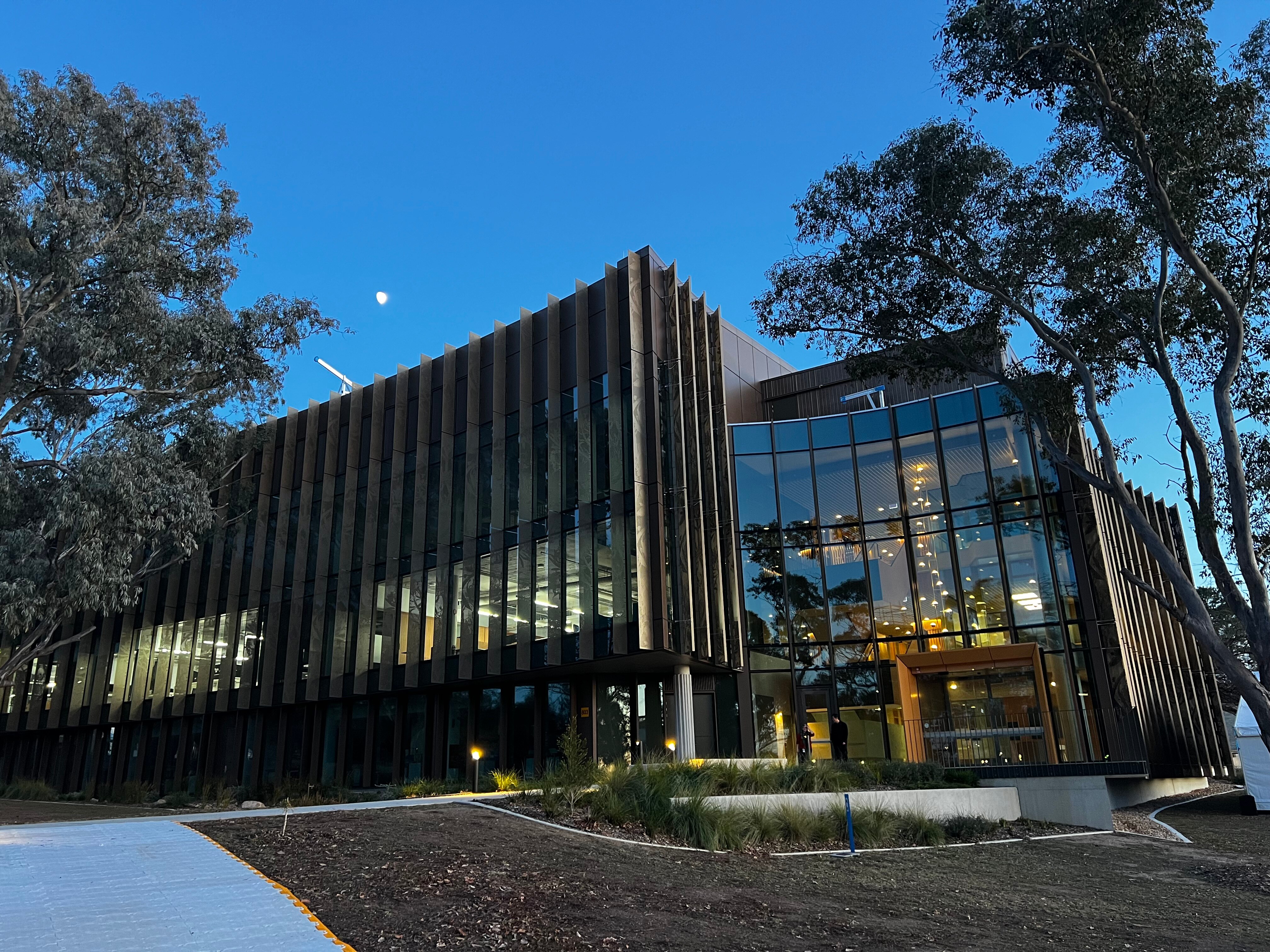 A large building with a lot of windows against a clear sky.