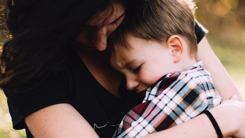 Mother with distressed child on lap