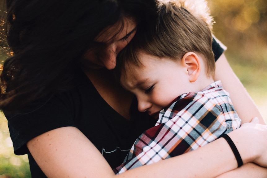 Mother with distressed child on lap