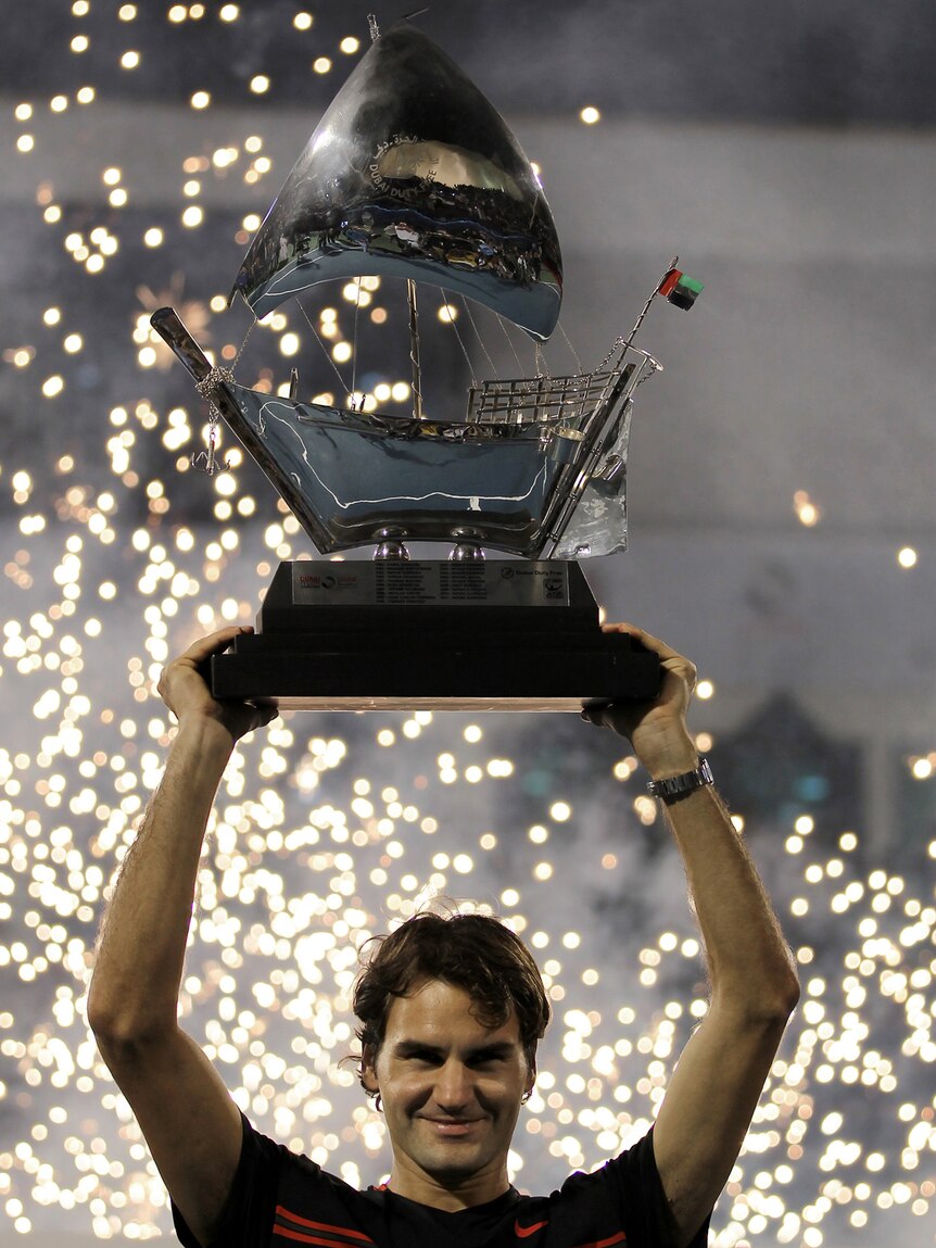 Roger Federer lifts the Dubai Open trophy