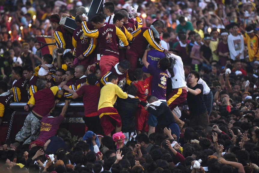 Catholics clamber over each other to touch Black Nazarene statue