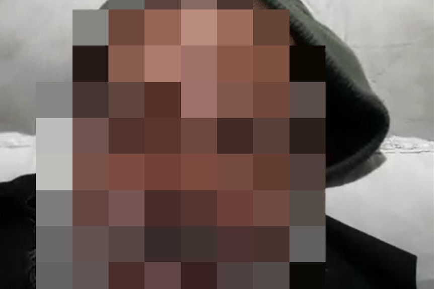 A man with his face blurred.