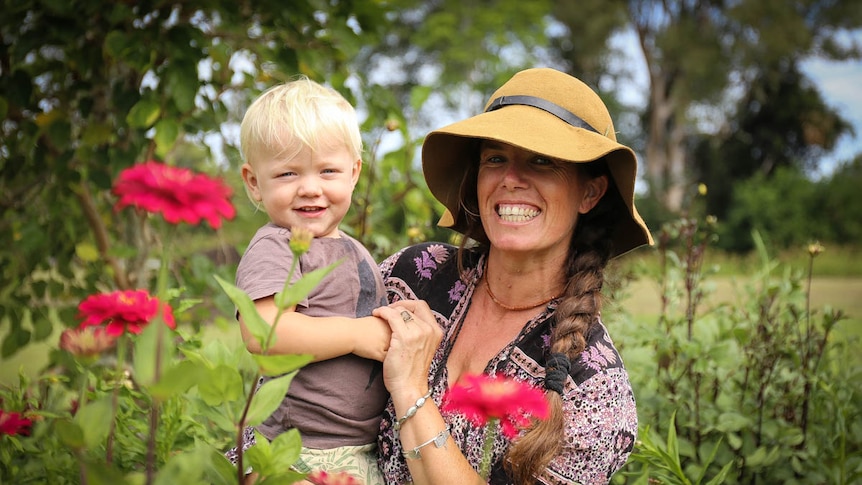 Hannah Lea Robertson holds her son Albie amongst field of flowers