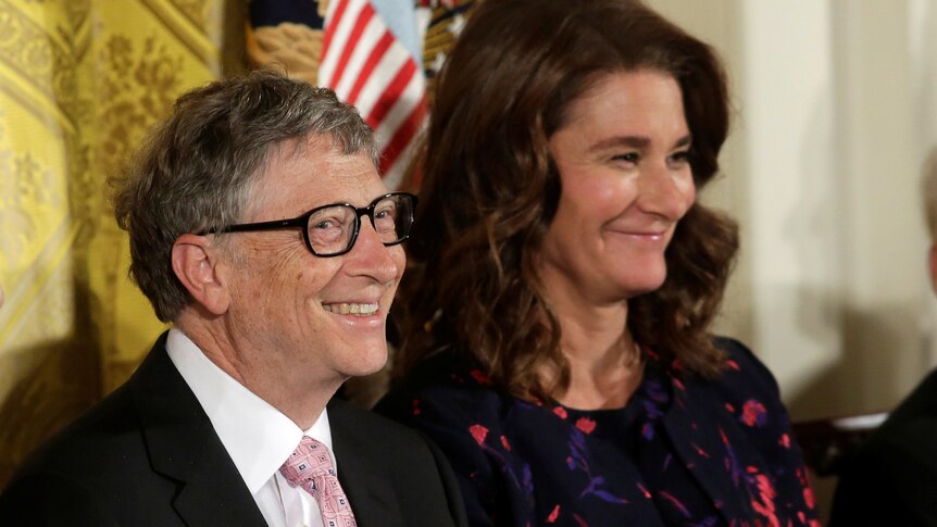 Bill Gates smiles at the camera while Melinda Gates smiles, looking in another direction. 