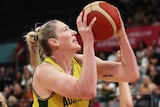 Lauren Jackson looks up with ball in hand under pressure from an opponent