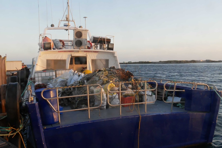 Piles of plastic on the back of a fishing vessel