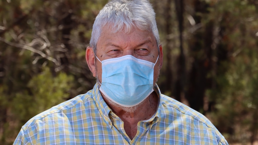 AMSANT CEO John Paterson stands outside wearing a face mask.