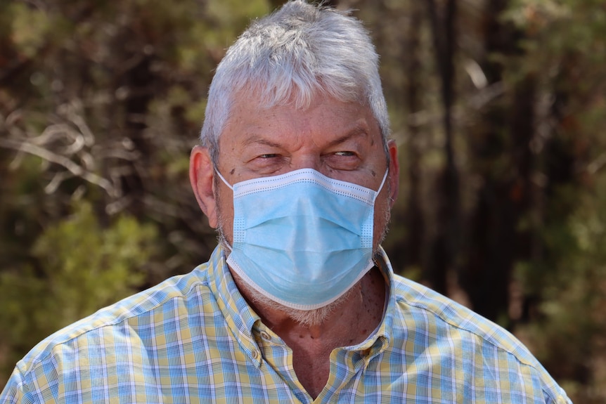 AMSANT CEO John Paterson stands outside wearing a face mask.